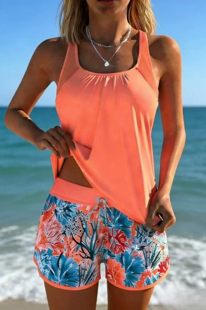 Women's Ocean Breeze two-piece tankini swimsuit. Mid-waist bottom and marine print top for poolside chic.