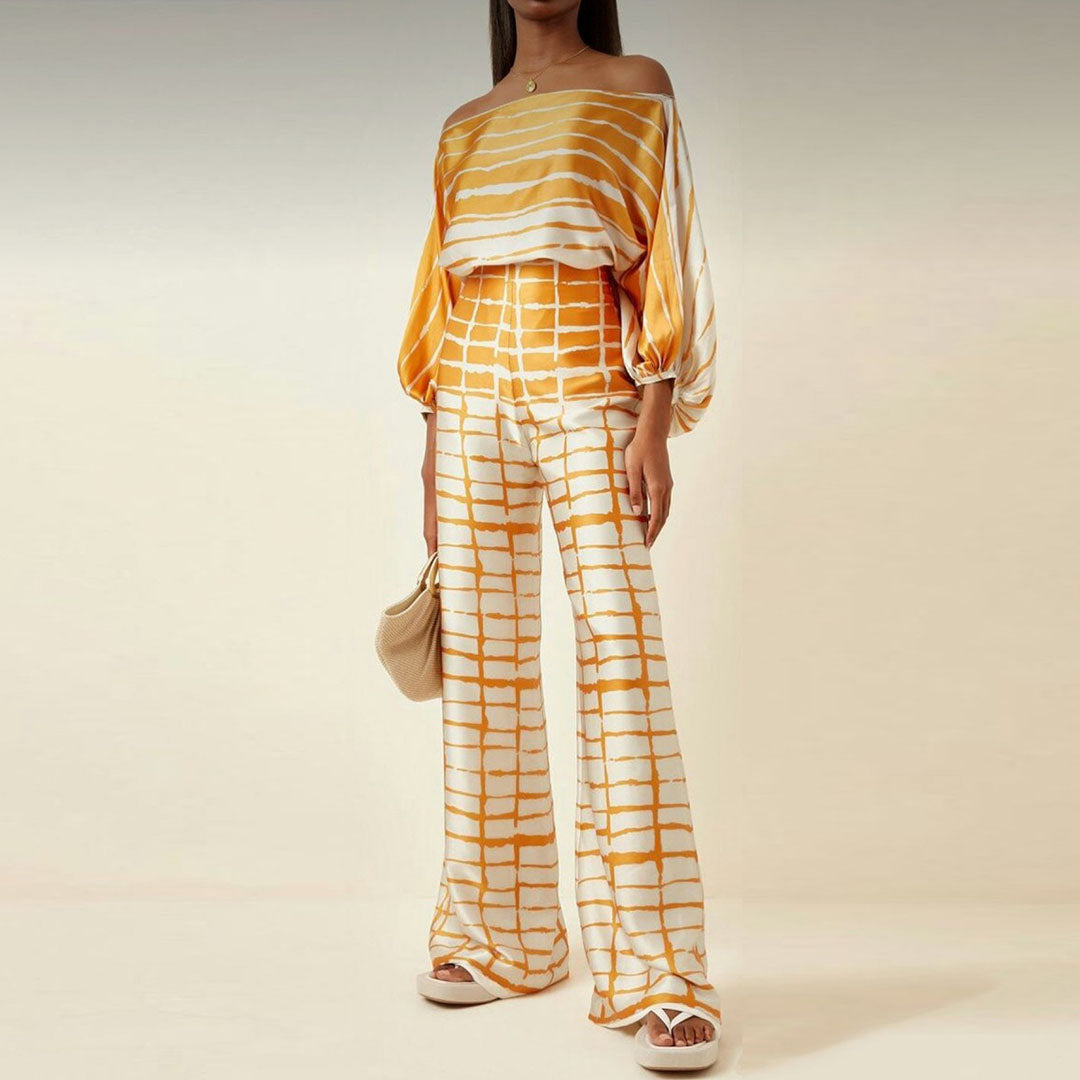 Vibrant printed women's co-ord set with a one-shoulder top & wide-leg pants. A stylish and comfortable two-piece outfit.