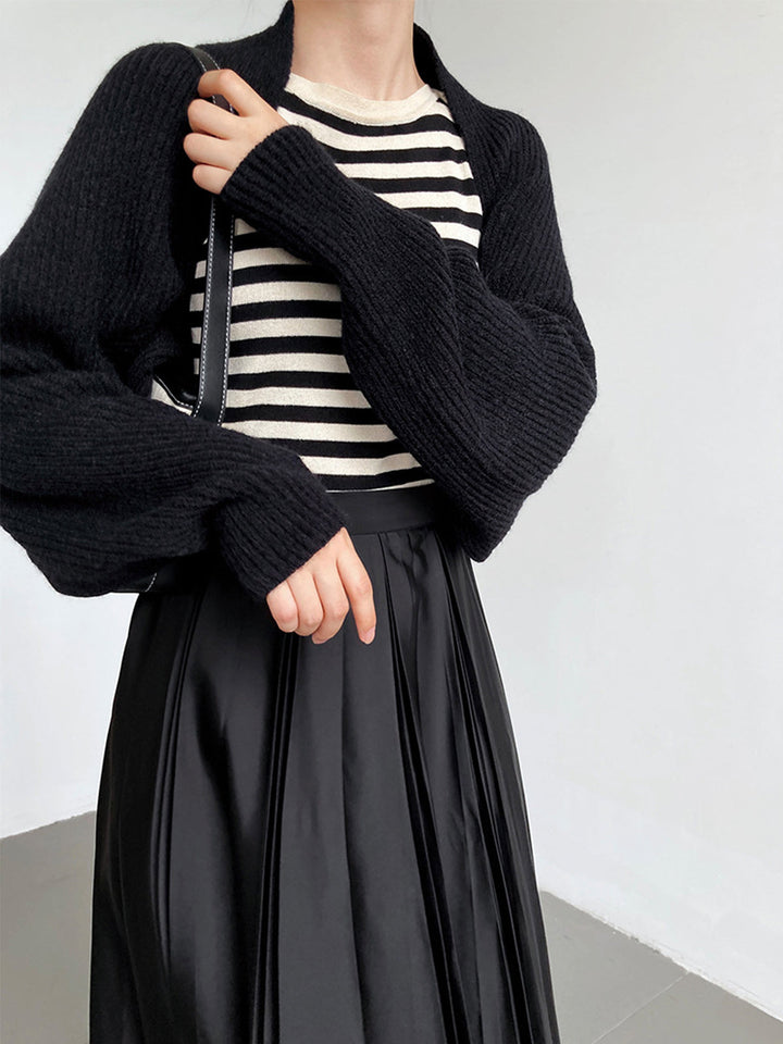 Stylish woman wearing an open-front long sleeve shrug sweater, perfect for adding a chic layer.