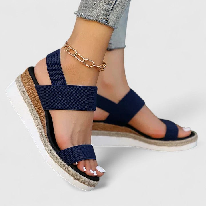 Angled shot of women's orthopedic open-toe wedge sandals, showcasing arch support & casual style.