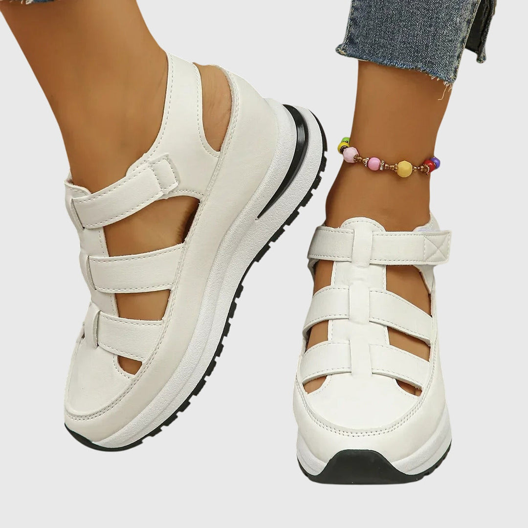 Woman wearing comfortable orthopedic sandals with adjustable arch support, perfect for casual summer strolls.