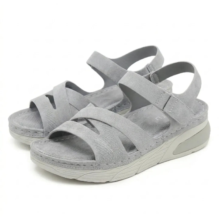 Orthopedic sole of women's comfort sandals with arch support, featuring adjustable straps for walking.