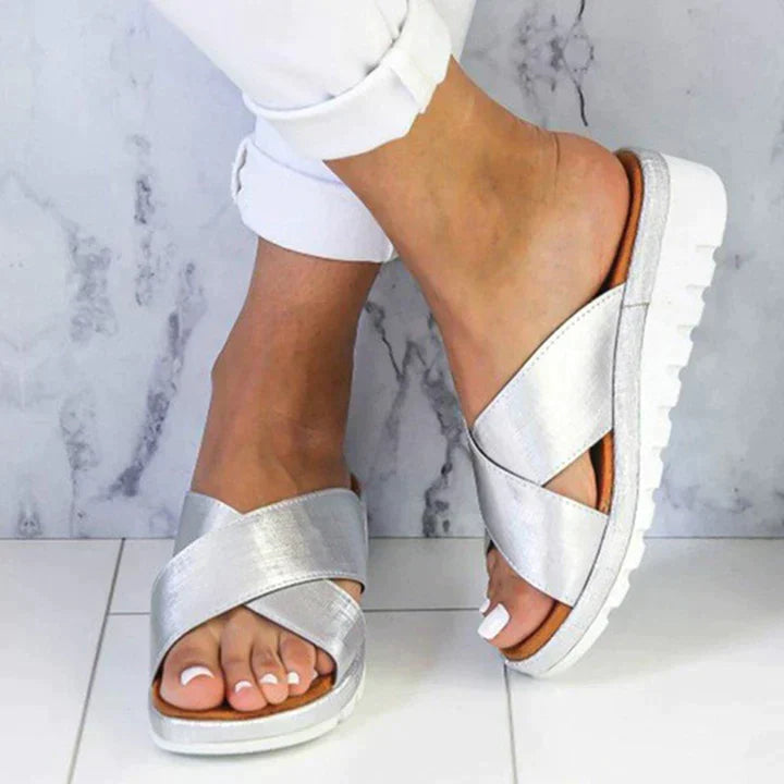 Women's orthopedic sandals with adjustable straps, providing comfort and arch support for daily wear.