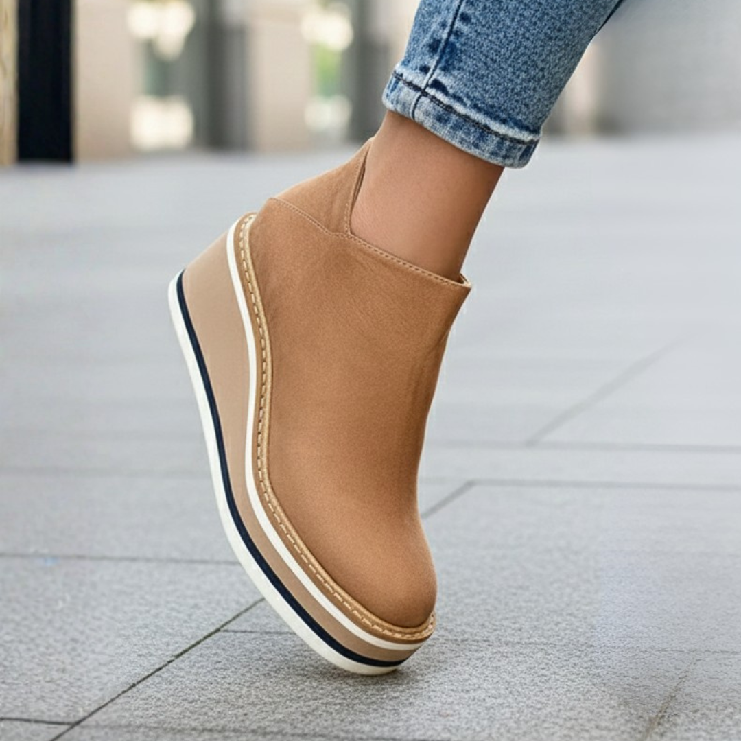 Comfortable women's orthopedic ankle boots featuring a stable wedge heel and side zipper.