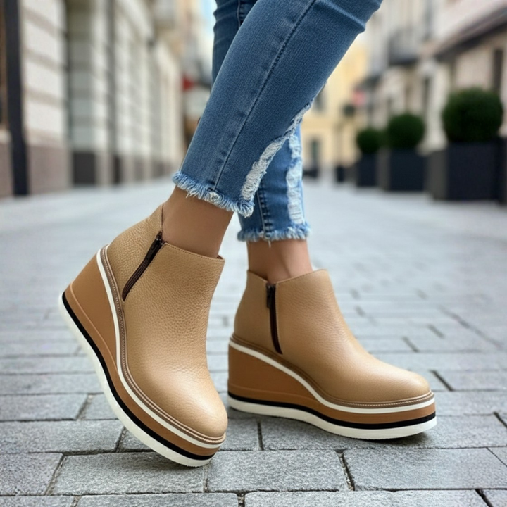 Versatile women's black wedge heel orthopedic ankle boots, providing support and elegant style.