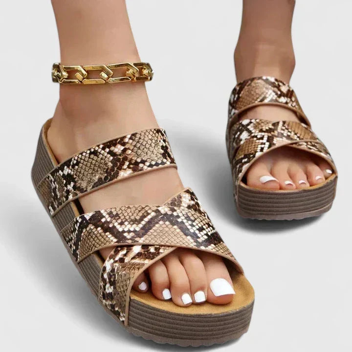 Women's resort-style wedge platform sandals with woven crossover straps, perfect for comfortable summer days.
