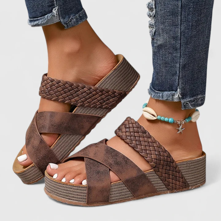 Close-up of women's orthopedic wedge platform sandals showing the intricate woven crossover strap detail.