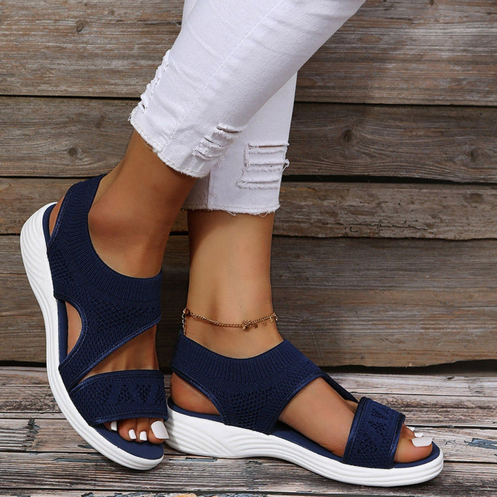 Comfortable women's orthopedic wedge sandals. Features elastic crossover straps, open toe design, & supportive wedge heel.