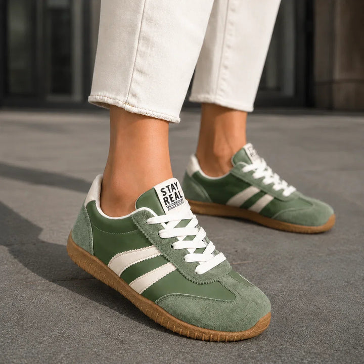 Woman walking in comfortable arch support orthopedic trainers. Ideal wide fit supportive footwear for daily activity.
