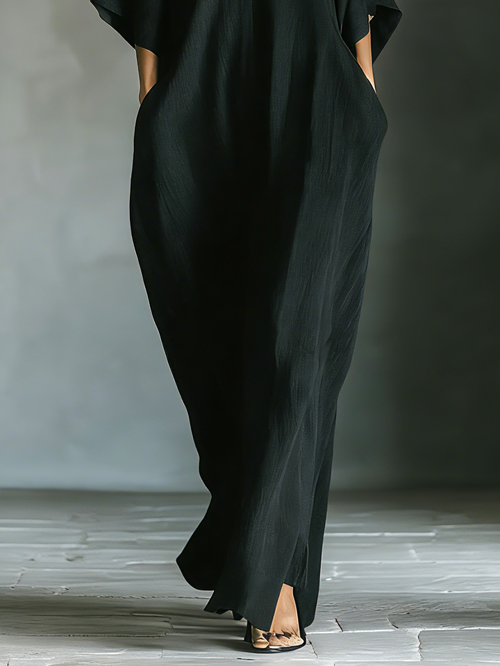Black oversized maxi dress for women featuring elegant kimono sleeves & essential pockets, a casual spring outfit.