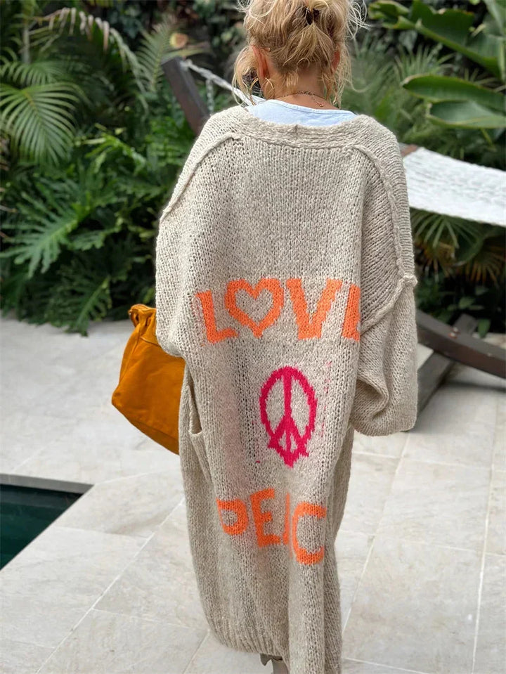 Long open front bohemian women's cardigan with "Peace" slogan, relaxed oversized fit, statement piece.