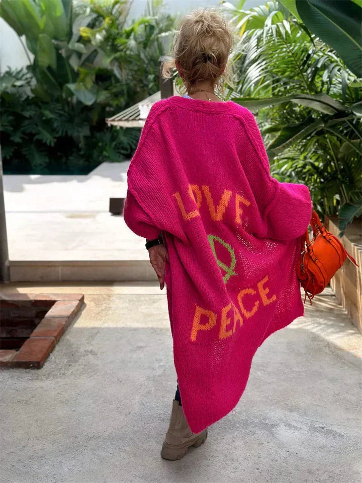 Women's colorful oversized knit cardigan with "Peace" slogan, bohemian style, relaxed longline fit.