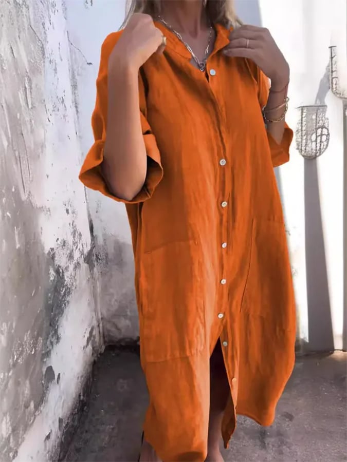 Front view of a women's oversized button-down midi shirt dress, showcasing pockets and relaxed fit.