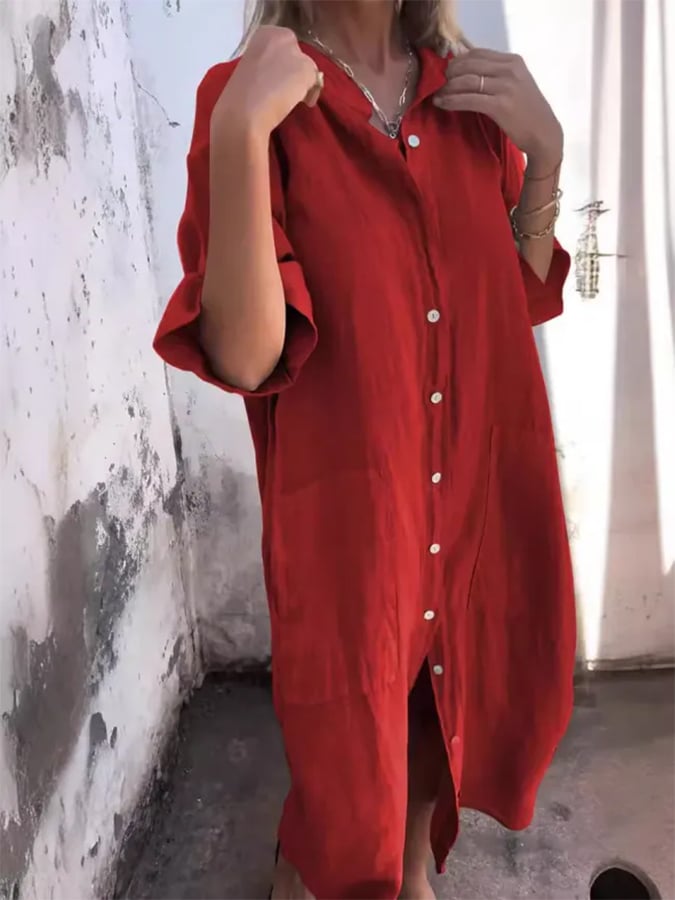 Woman models a casual oversized button-down midi shirt dress with pockets. Stylish easy wear.