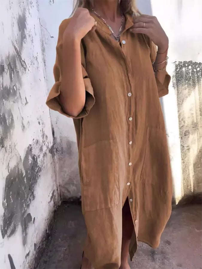 Woman wears an oversized button-down midi shirt dress as a chic beach cover-up for summer fashion.