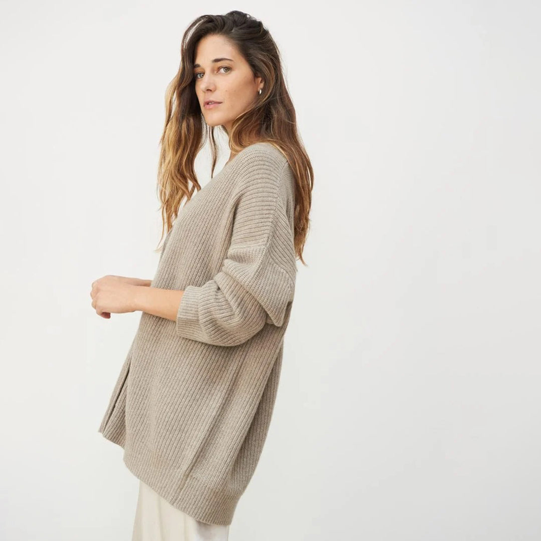 Woman wearing a cozy oversized button-up cardigan, styled for a relaxed fall look.
