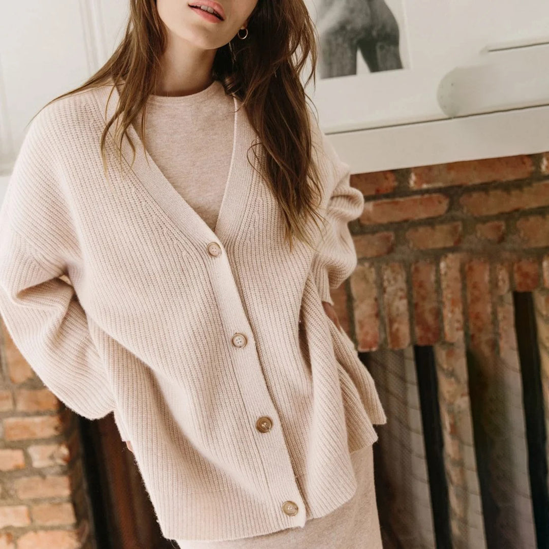 Oversized women's sweater cardigan with full button-up front, combining comfort & style.