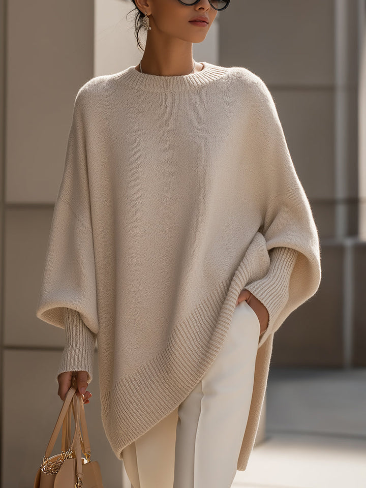 Women's oversized cape sweater with batwing sleeves, perfect for elegant layering.