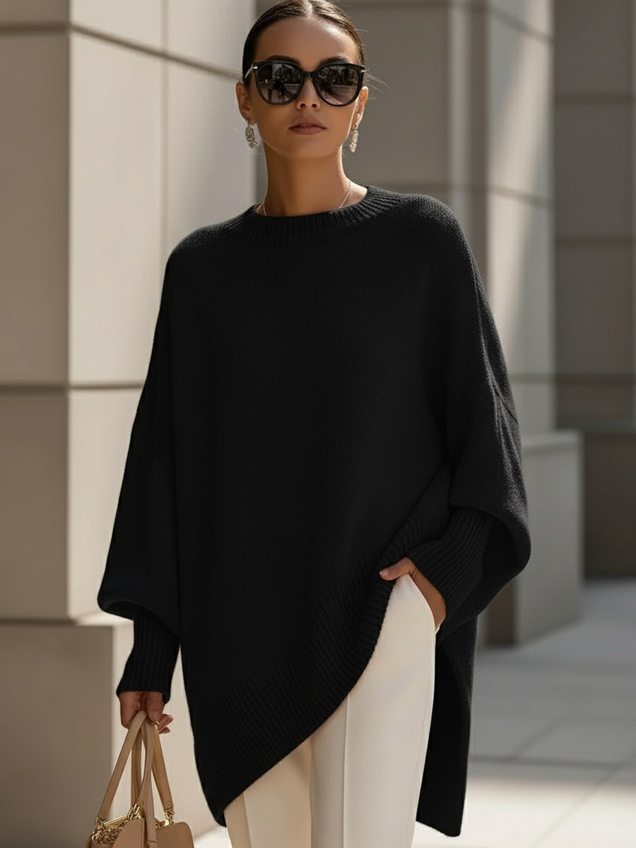 Women's oversized poncho sweater with batwing sleeves, warm & chic for cold weather.