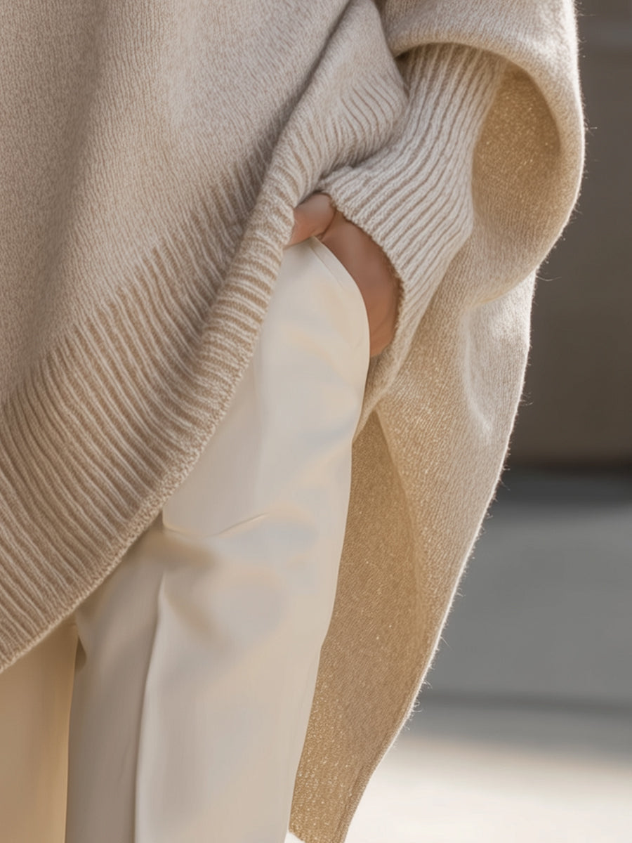Warm knit oversized women's sweater, poncho style with batwing sleeves for winter.