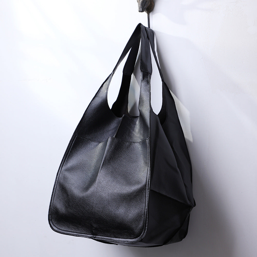 Practical women's oversized shoulder bag in a soothing blue, a spacious everyday tote for comfort & style.