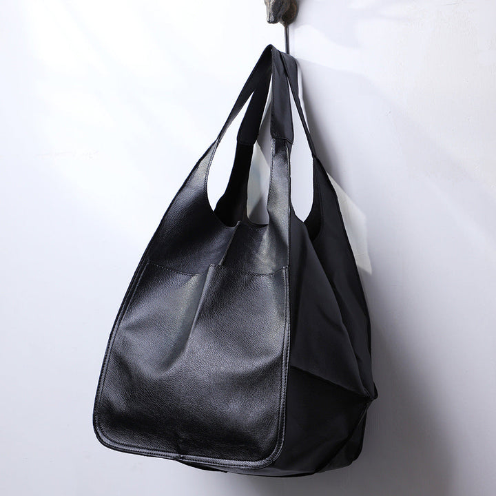 Practical women's oversized shoulder bag in a soothing blue, a spacious everyday tote for comfort & style.