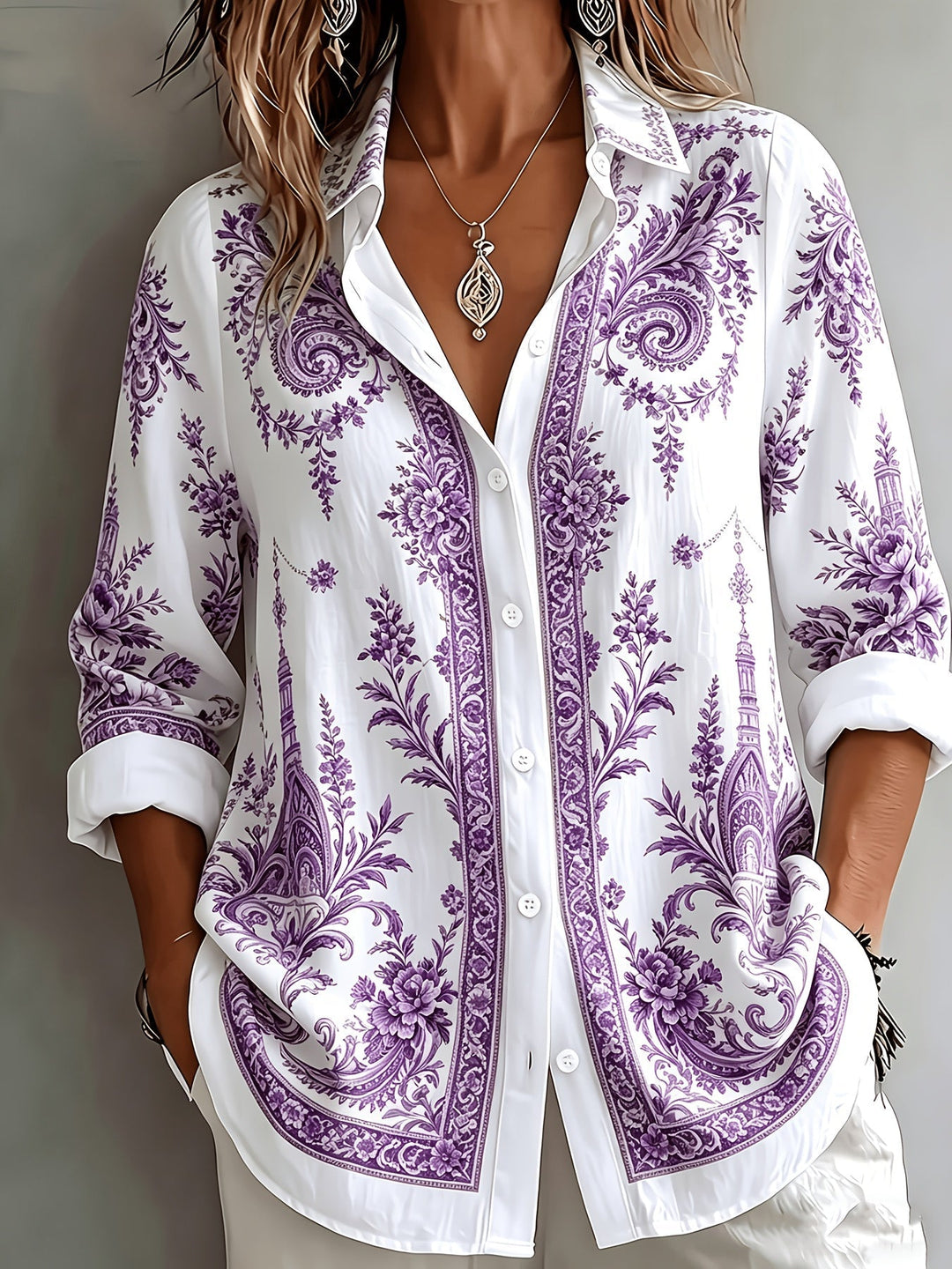 Woman modelling a flowing floral paisley oversized long sleeve blouse. Perfect for a chic summer look.