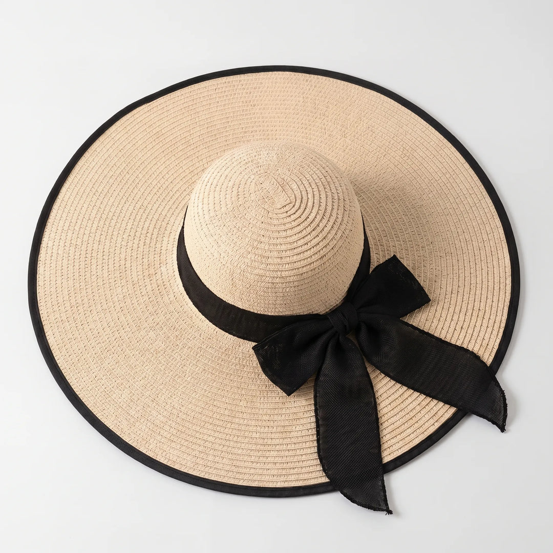 Chic women's wide brim sun hat, ideal summer accessory for resort, beach, or travel vacation.