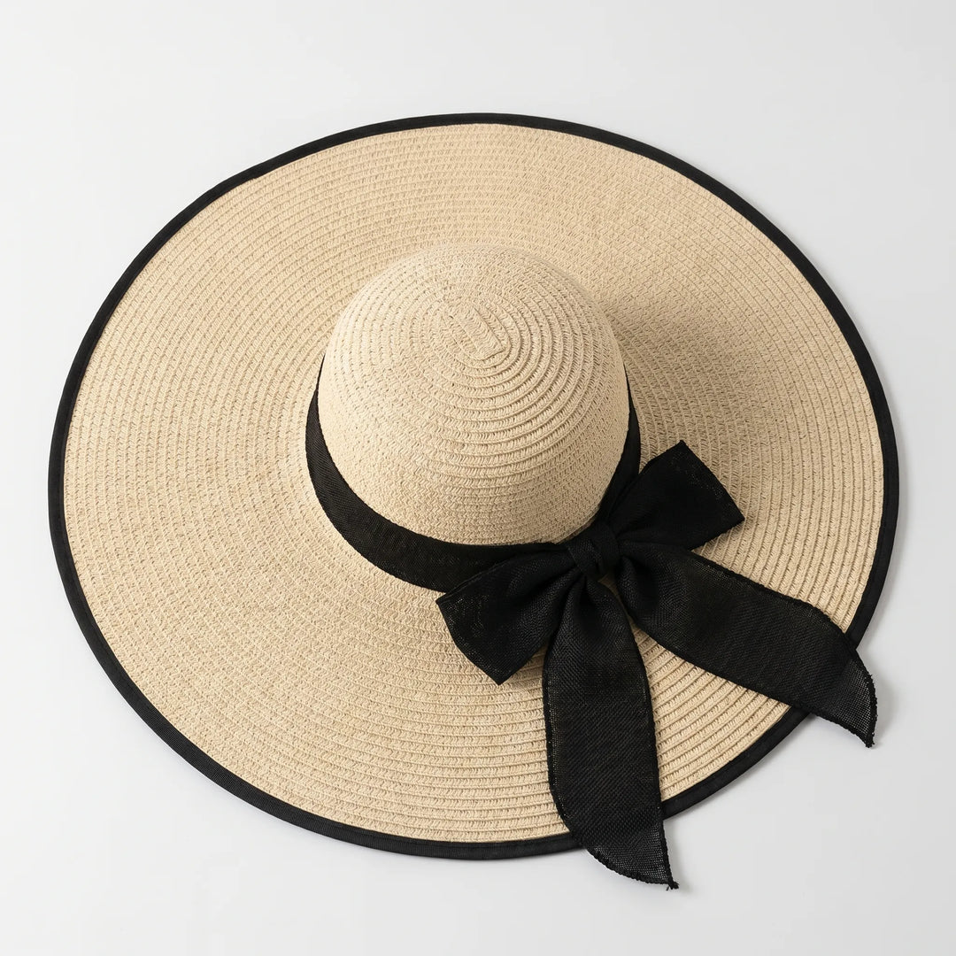 Women's beach sun hat, featuring a wide brim for vacation style & essential UV protection.