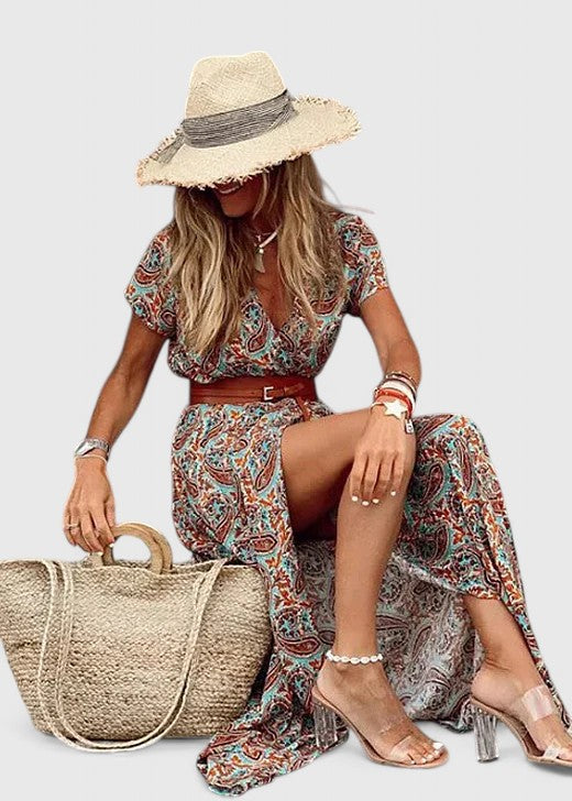 Elegant women's paisley maxi dress featuring V-neck, short sleeves, a flattering self-tie belt, and side slit.