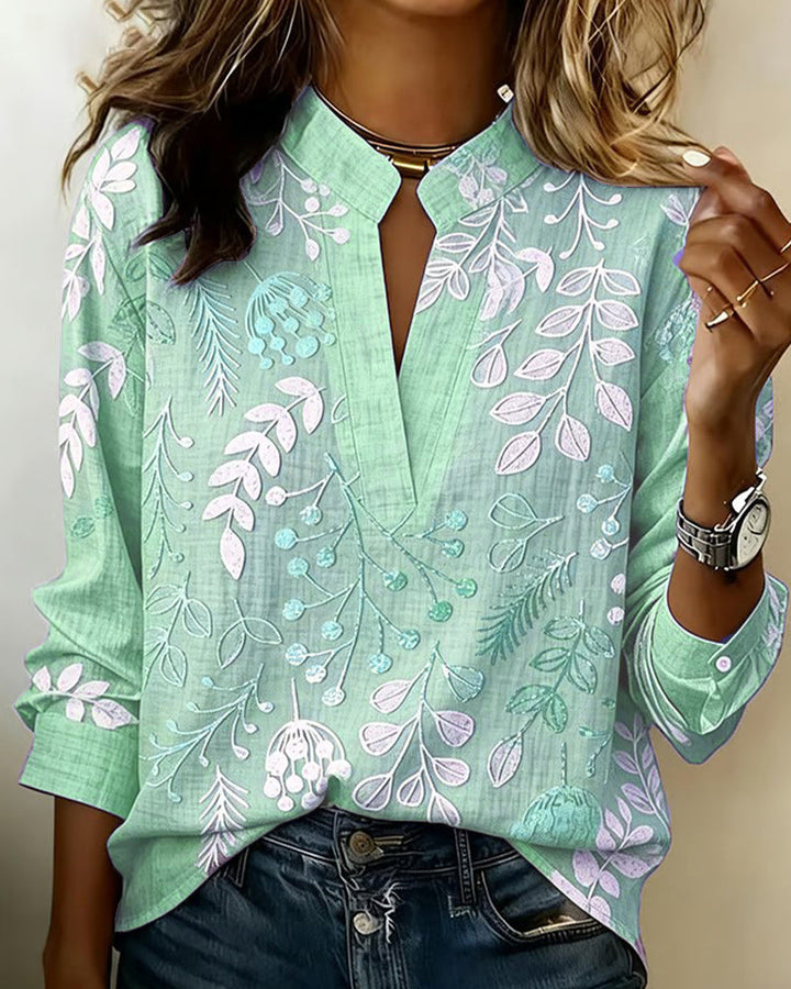 Women's v-neck floral top in soft pastel hues, ideal for elegant spring ensembles.
