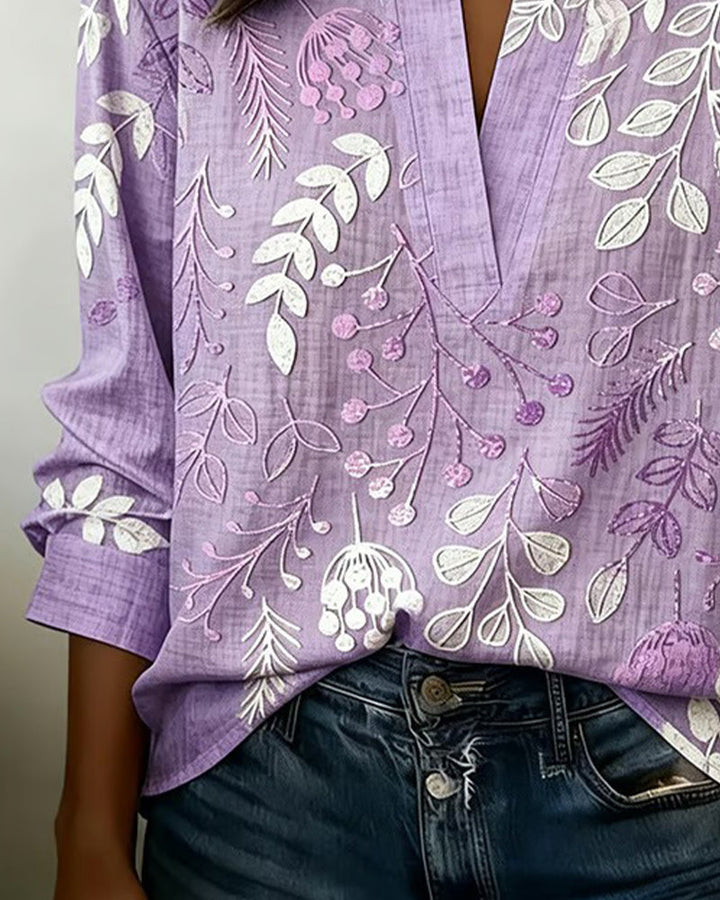 Chic pastel floral v-neck women's top in blue, versatile for casual or office wear.