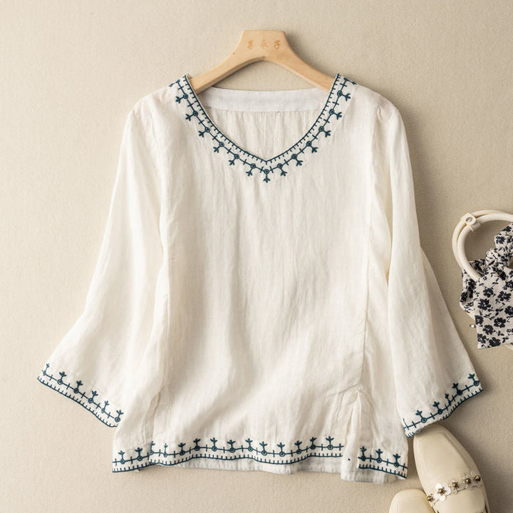 Women's patterned V-neck short sleeve blouse, perfect for elegant casual wear. Chic spring/summer fashion top.