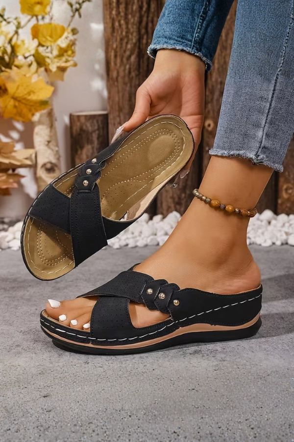 Stylish women's perforated wedge sandals, comfortable slip-on design, breathable summer footwear.