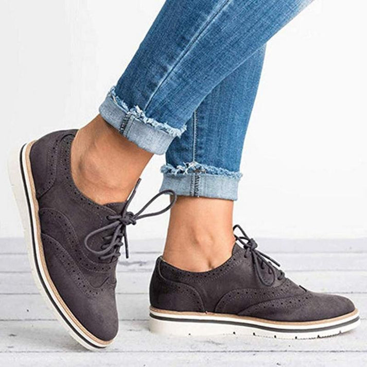 Black women's lace-up Oxford sneakers with brogue detail. Versatile casual shoes, smart casual & vintage fashion.