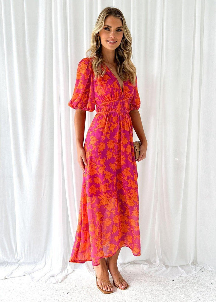 Flowing pink orange floral maxi dress with V-neck & puff sleeves, ideal women's summer fashion & brunch wear.