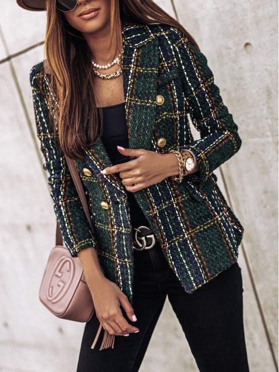 Close-up of a women's plaid tailored blazer, highlighting the double-breasted cut & intricate gold buttons. Fall office wear.