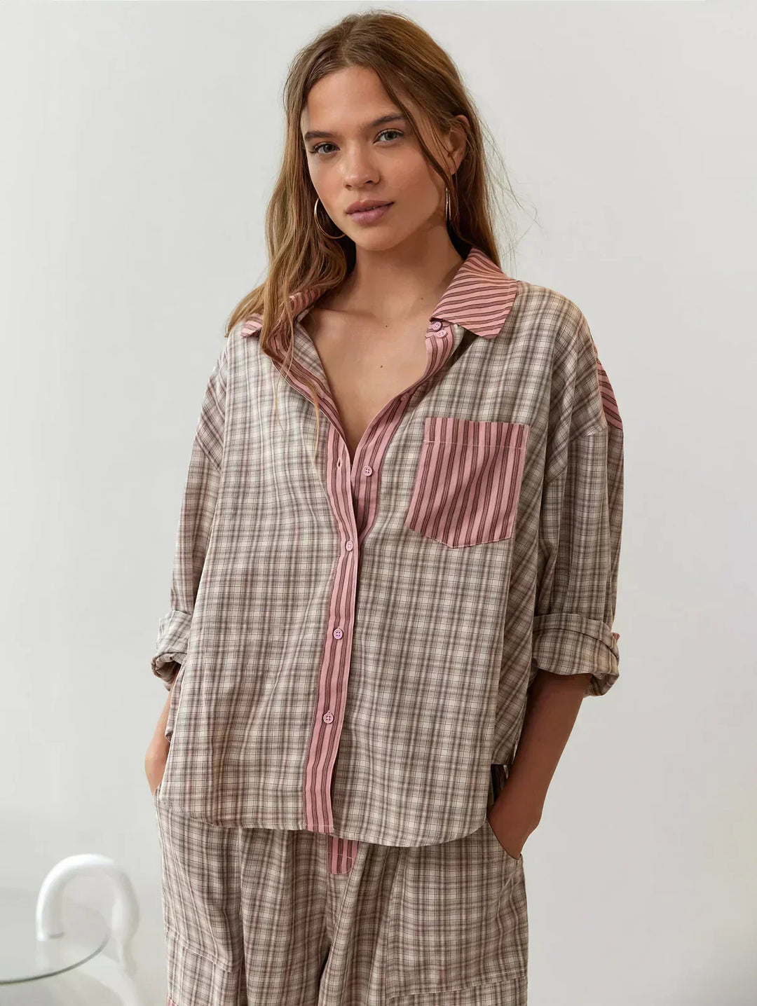 Women's plaid pajama set with a button-up shirt and relaxed fit pants, ideal for cozy sleepwear and loungewear.