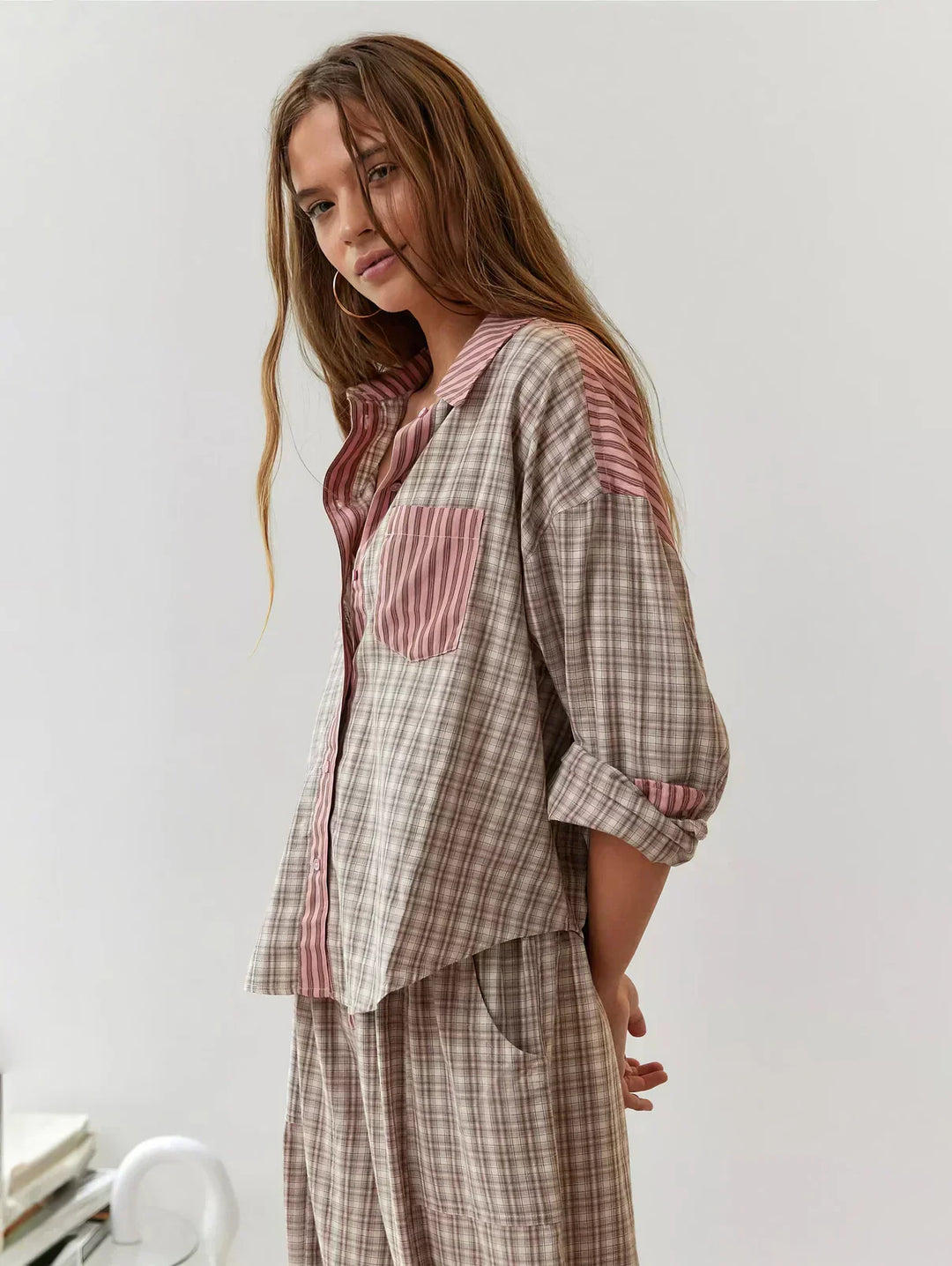 Cozy women's two-piece plaid pajama set. Soft fabric, button-up top, and relaxed pants for ultimate comfort.