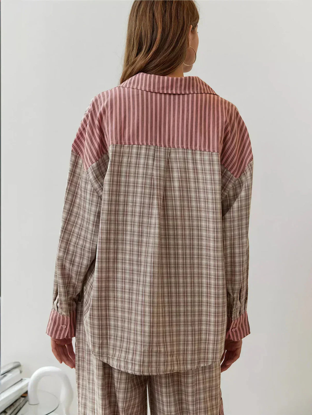 Stylish women's button-up plaid pajama shirt with long sleeves, part of a comfortable two-piece sleepwear set.
