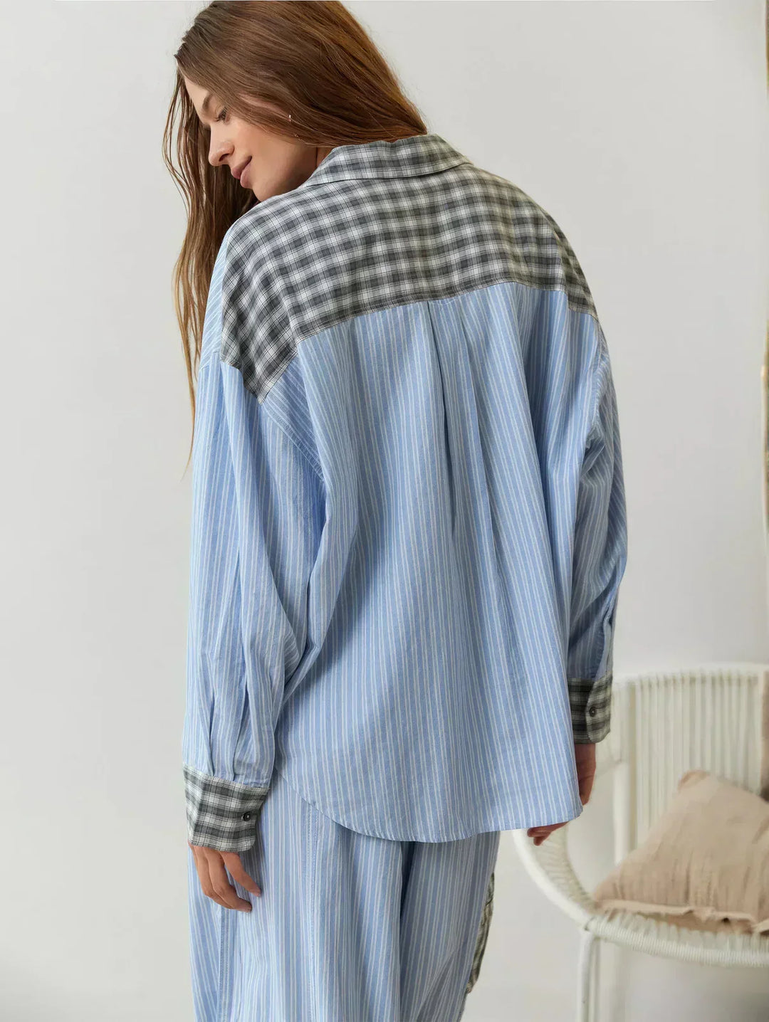 Model wearing a comfortable women's plaid loungewear set; button-up pajama shirt and relaxed fit sleep pants.