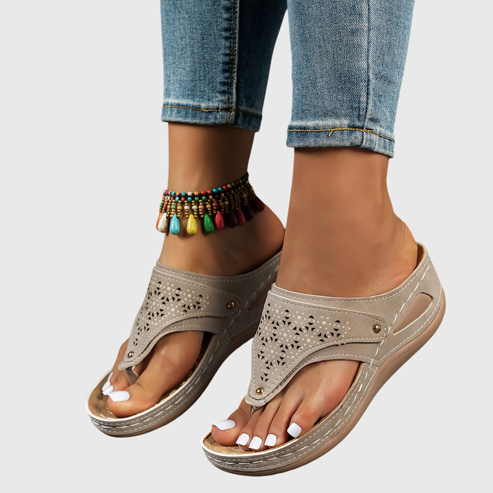 Elegant women's platform sandals with ankle strap & perforated design, ideal for summer style.
