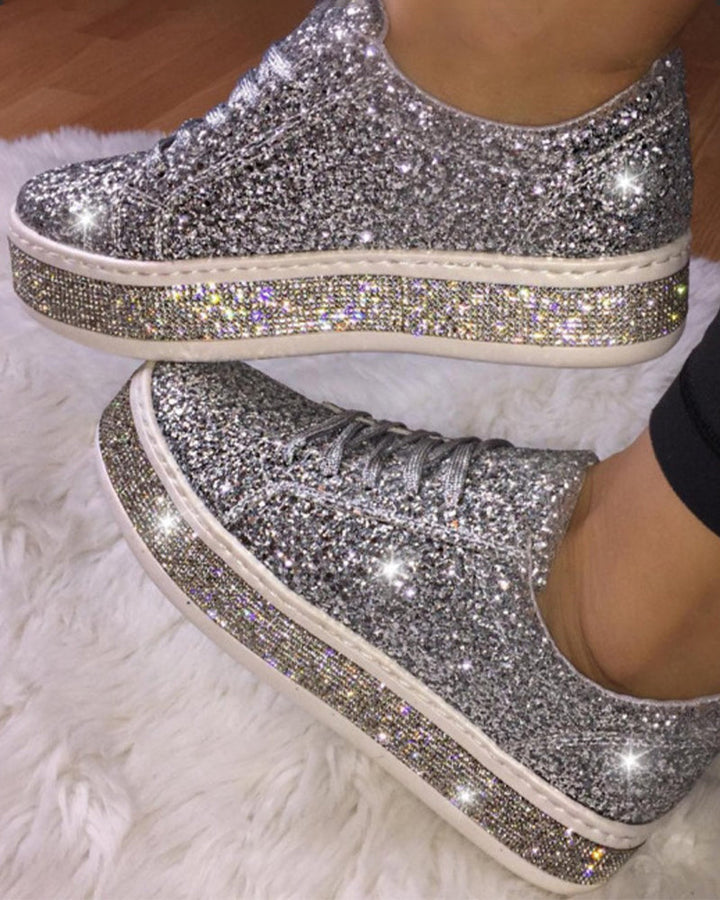 Women's platform glitter sneakers, perfect for chic everyday wear. Sparkle & comfort.