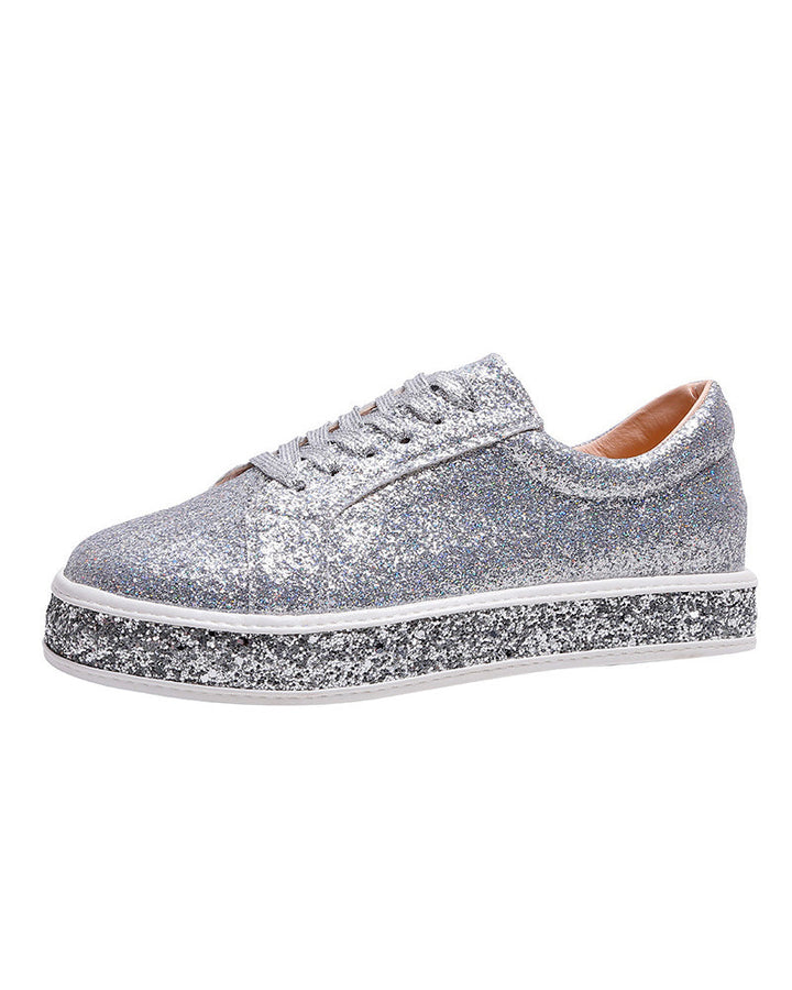 Detail of women's platform glitter sneakers, highlighting comfortable design & trendy platform.