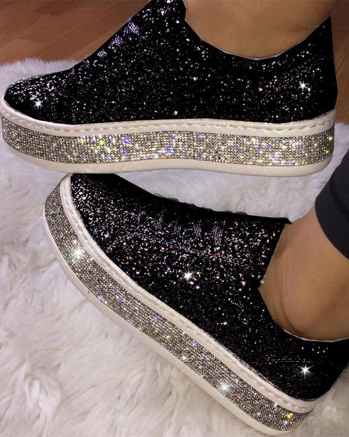 Stylish women's platform sneakers with shimmering glitter finish. Casual fashion footwear.