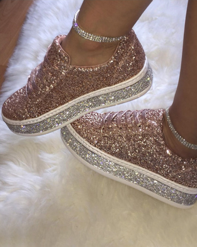 Elevated platform sole on women's glitter sneakers for a trendy look & comfortable stroll.