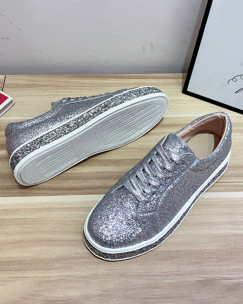 Women's platform glitter sneakers in action, showcasing casual style & sparkle.