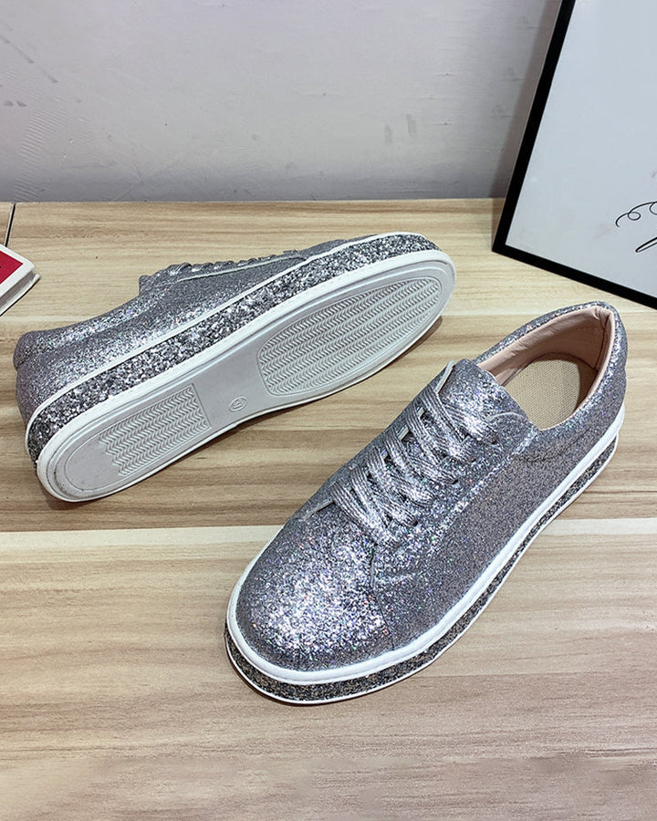 Women's platform glitter sneakers in action, showcasing casual style & sparkle.