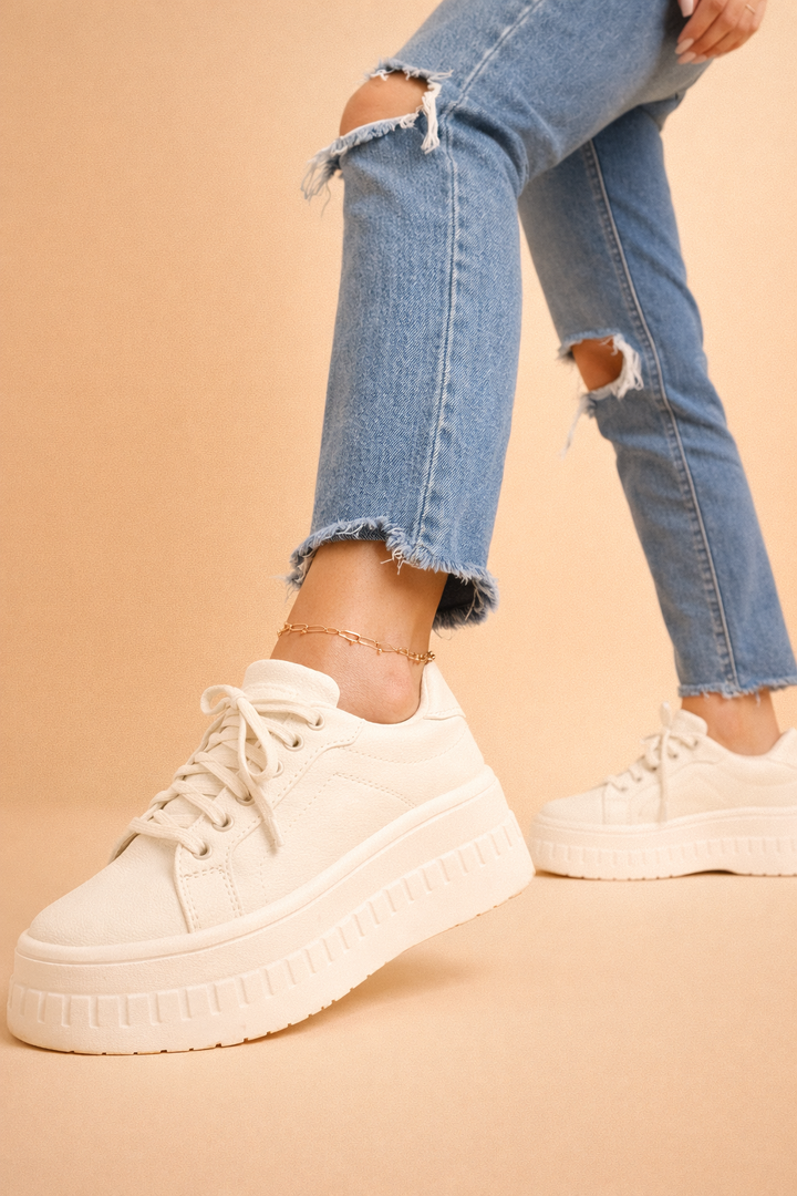 Fashionable women's platform sneakers featuring a high cushioned sole for ultimate comfort and height.