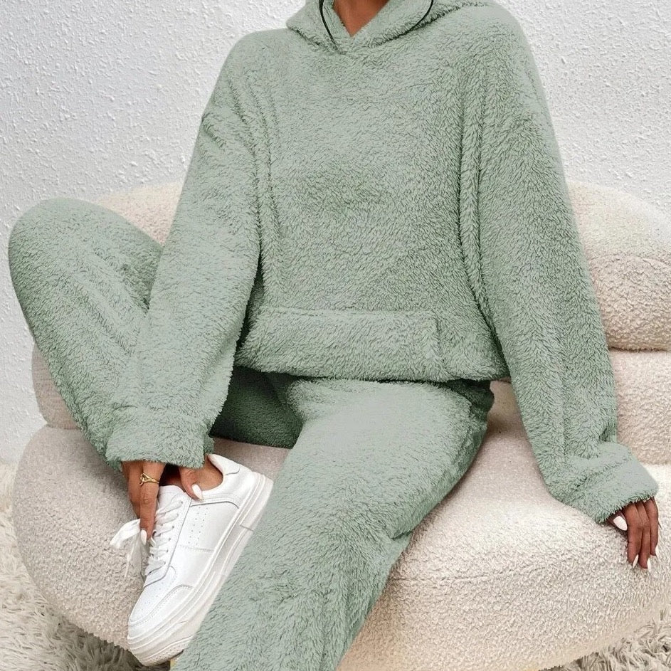 Woman modeling a plush women's loungewear set. Warm hoodie & pants for ultimate comfort and casual style.
